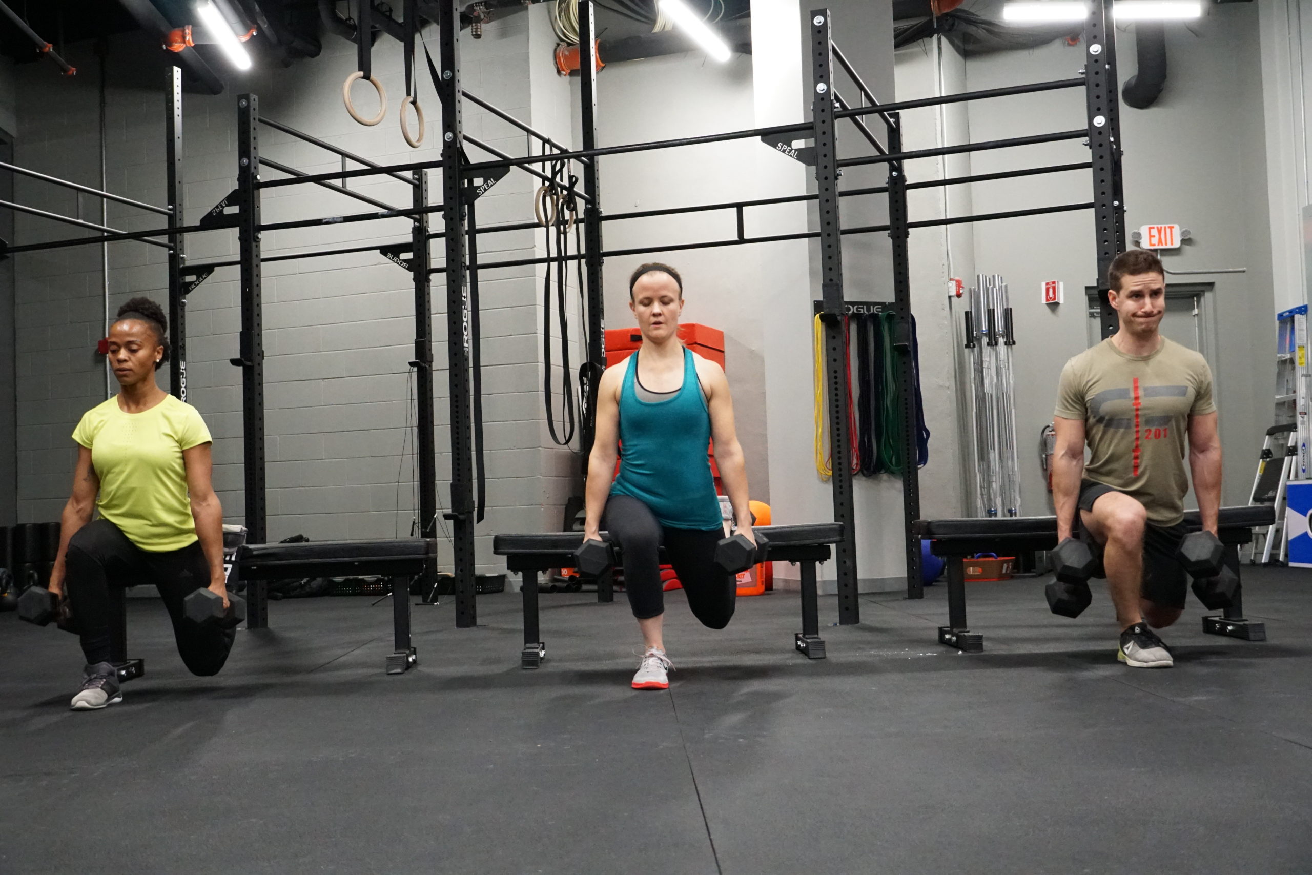 Athletes performing weighted lunges