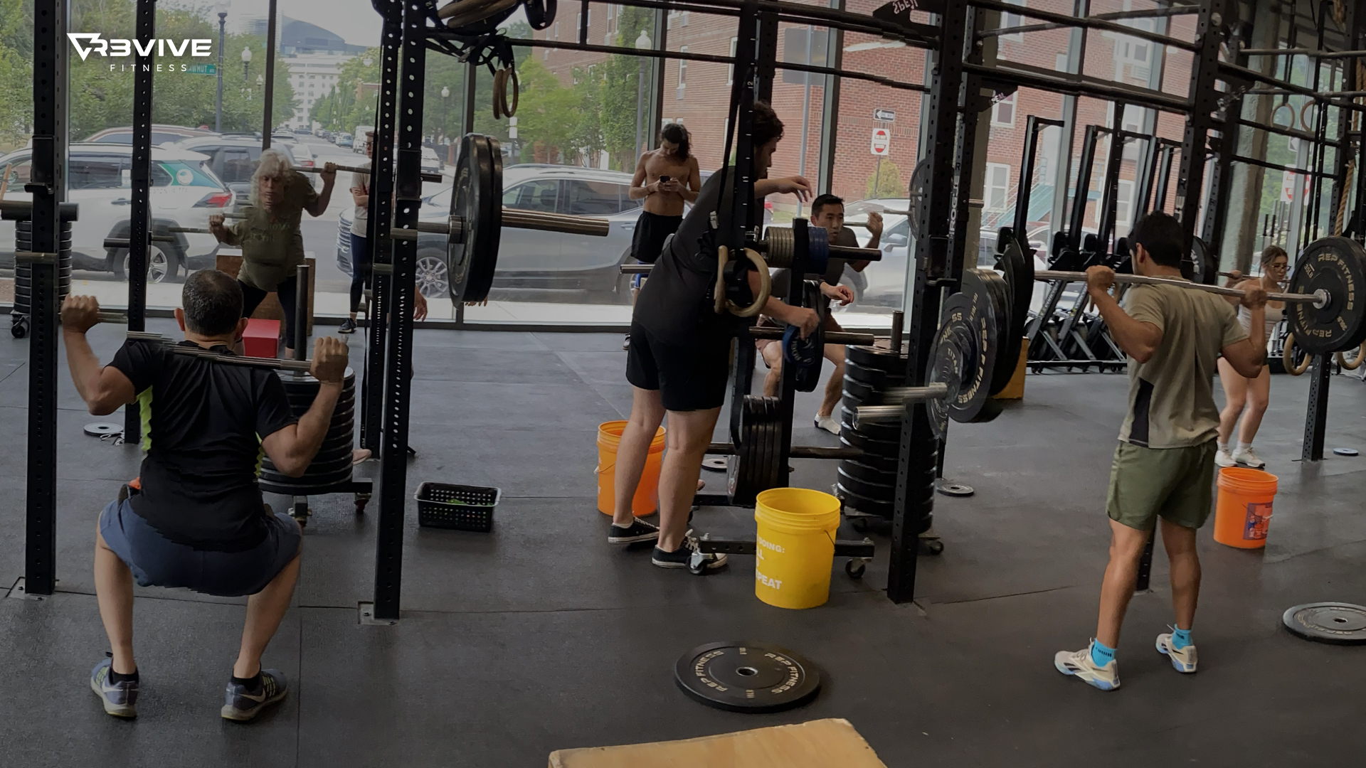 A group of members performing backsquats